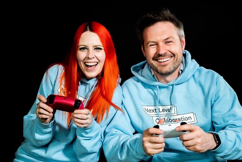 jess rowlings and dr matt harrison together holding game controllers smiling